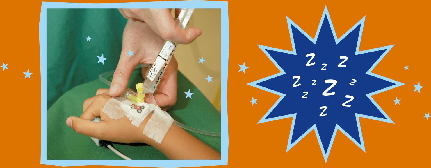 Lucas gets an injection into the plastic tube that is attached to a blood vessel in his hand.